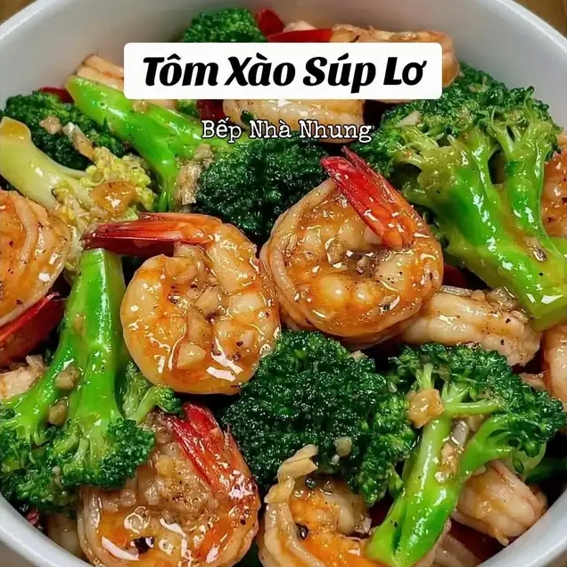 Món tôm xào súp lơ hấp dẫn với tôm màu cam bóng bẩy và súp lơ xanh tươi được trình bày trong tô trắng