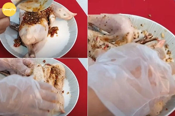 Nhét các tép tỏi nguyên và gia vị đã trộn đều vào sâu trong bụng con gà
