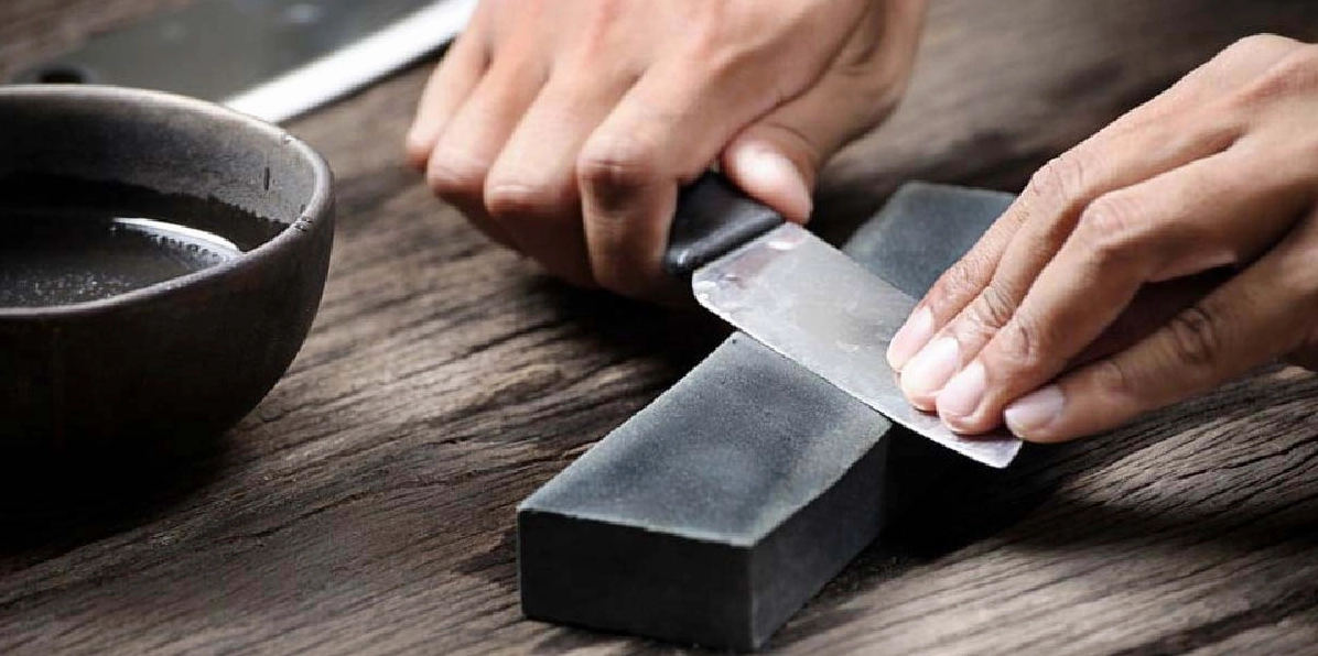 Thao tác mài dao sắc trên bề mặt đá mài một cách cẩn thận